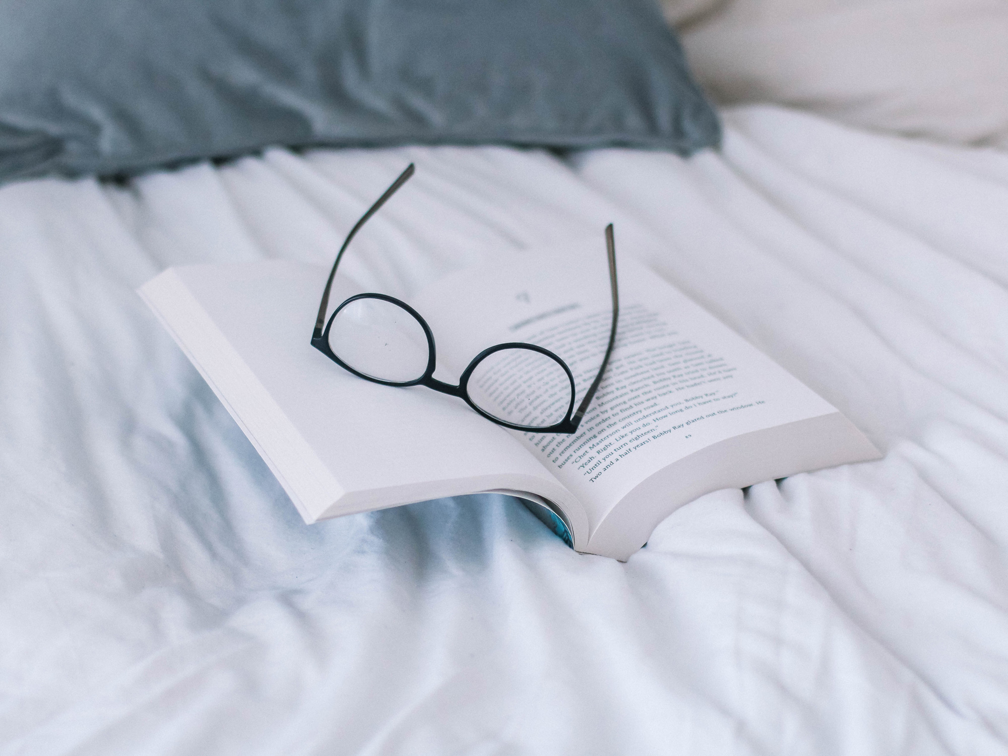 glasses on an open book - New books to read featured by top US life and style blog, York Avenue